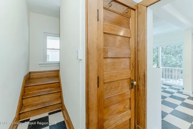 a view of an entryway with wooden floor and door