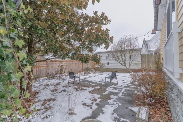 a view of a backyard with a large tree