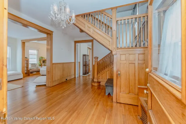 a view of entryway with wooden floor and stairs