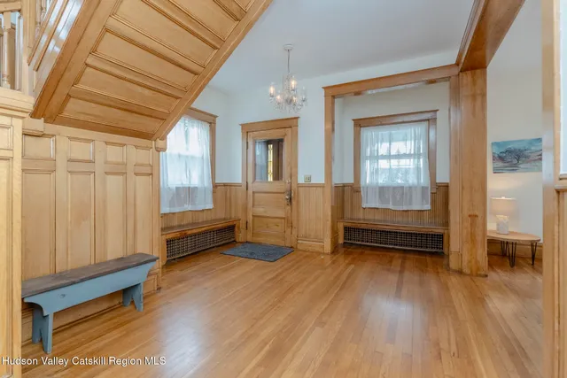 a view of a room with wooden floor and windows