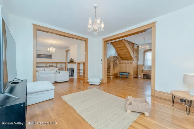 a living room with furniture and a chandelier