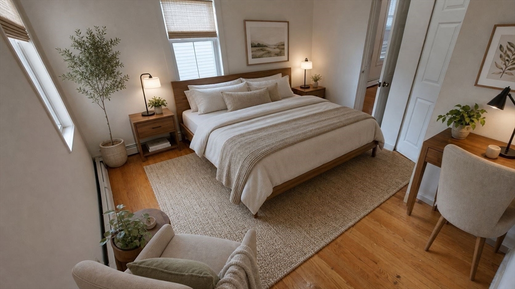 124 Marcella Street, Unit 1 Boston, MA 02119 - Photo 7 of 13 a bedroom with a bed chair and a potted plant