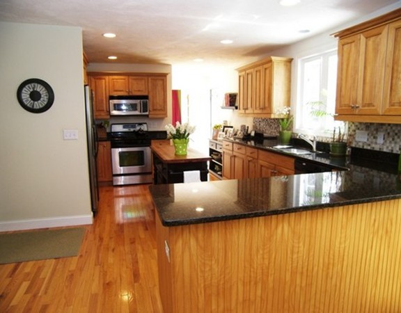 304 Flagg Hill Road Boxborough, MA 01719 - Photo 6 of 20 a kitchen with stainless steel appliances granite countertop a sink a stove top oven a chimney and a center island