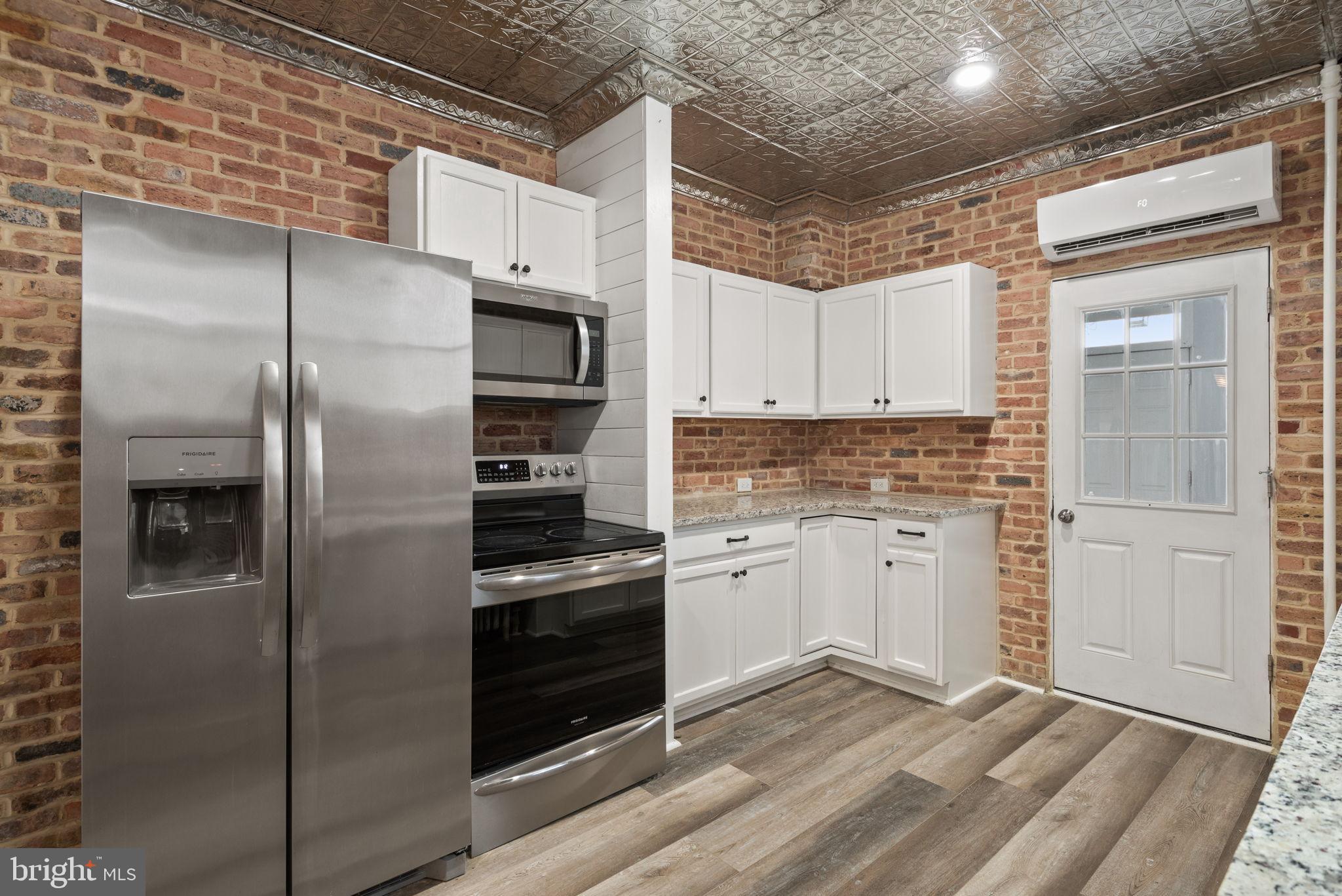 245 Jackson Street Lancaster, PA 17603 - Photo 12 of 38 a kitchen with stainless steel appliances granite countertop a refrigerator and a stove