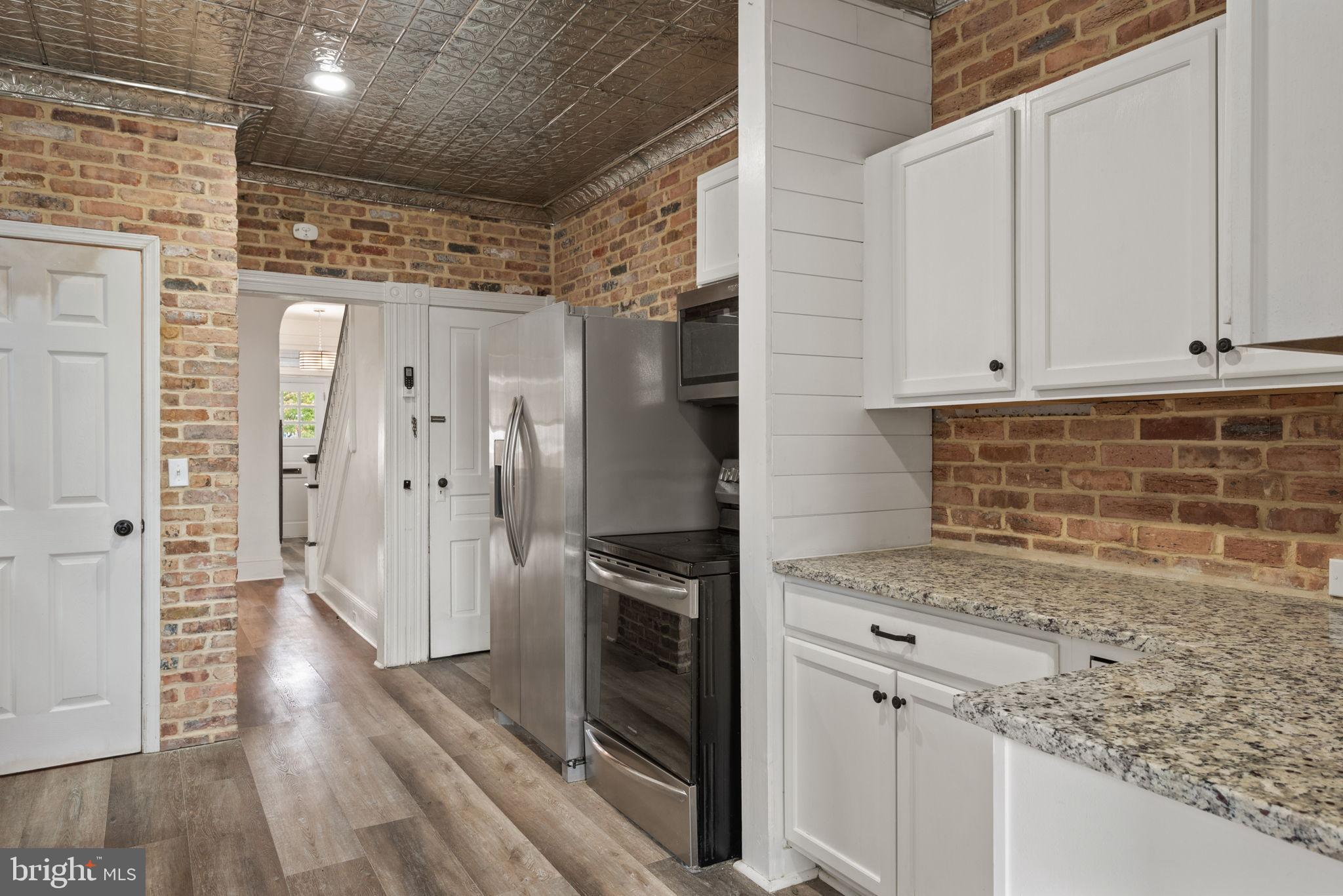 245 Jackson Street Lancaster, PA 17603 - Photo 13 of 38 a kitchen with granite countertop a refrigerator and a stove