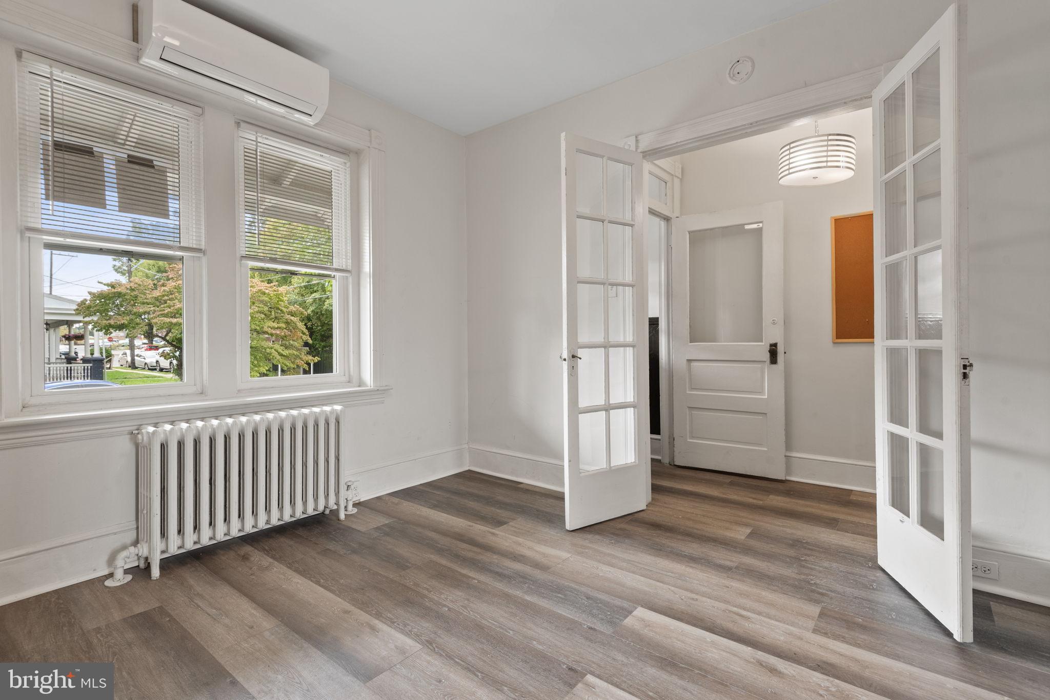 245 Jackson Street Lancaster, PA 17603 - Photo 4 of 38 an empty room with wooden floor and windows