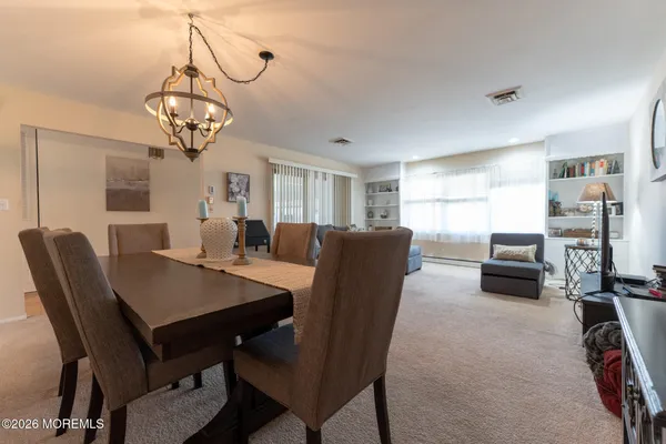a view of a dining room with furniture window and wooden floor