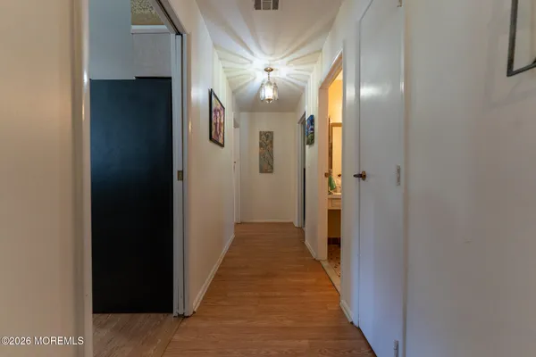 a view of a hallway with a chandelier