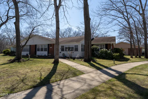 a view of a house with backyard and tree
