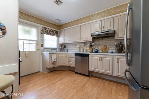 a kitchen with stainless steel appliances granite countertop a refrigerator sink and cabinets