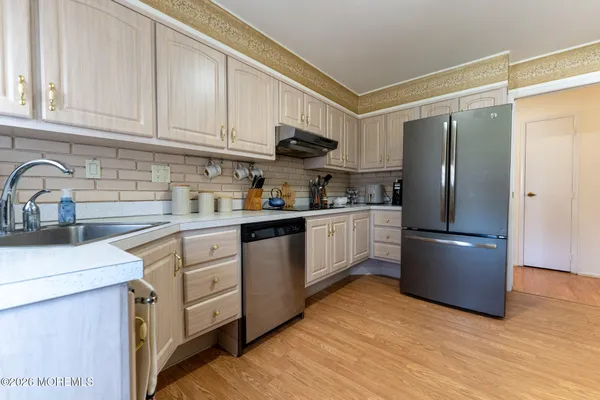 a kitchen with stainless steel appliances granite countertop a refrigerator sink and cabinets