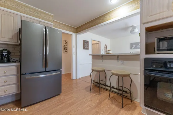 a kitchen with stainless steel appliances granite countertop a refrigerator and a stove top oven