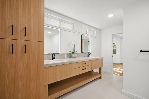 a bathroom with a double vanity sink and mirror