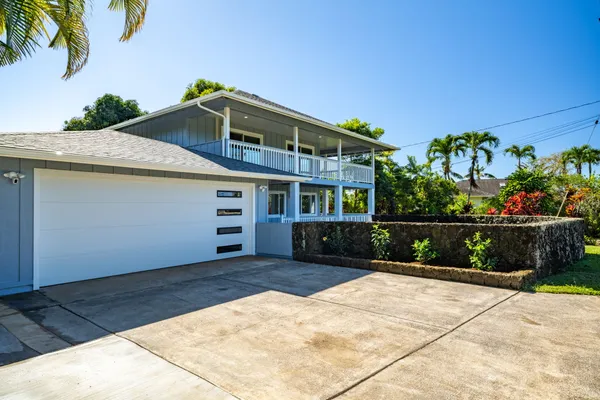 a view of a house with a backyard