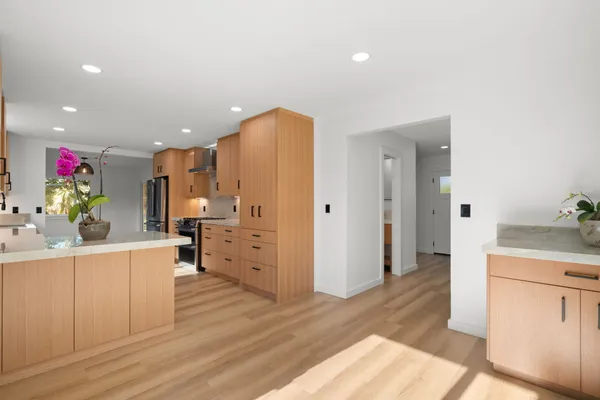 a kitchen with stainless steel appliances a refrigerator and a stove top oven