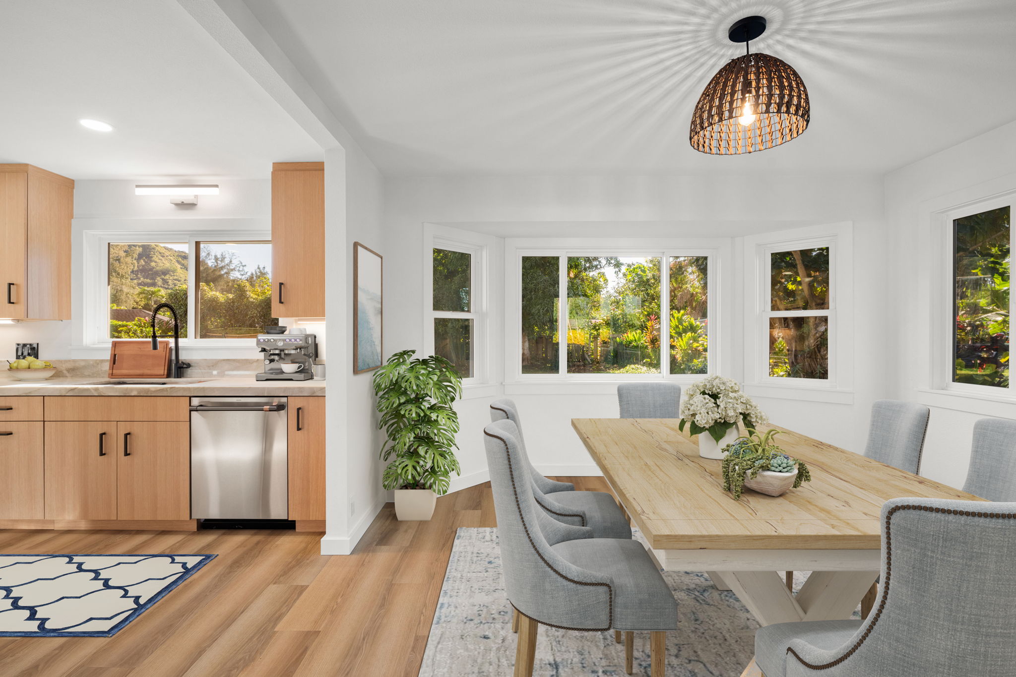 5611 Ohelo Road Kapaa, HI 96746 - Photo 9 of 30 a dining room with wooden floor a chandelier a wooden table and chairs