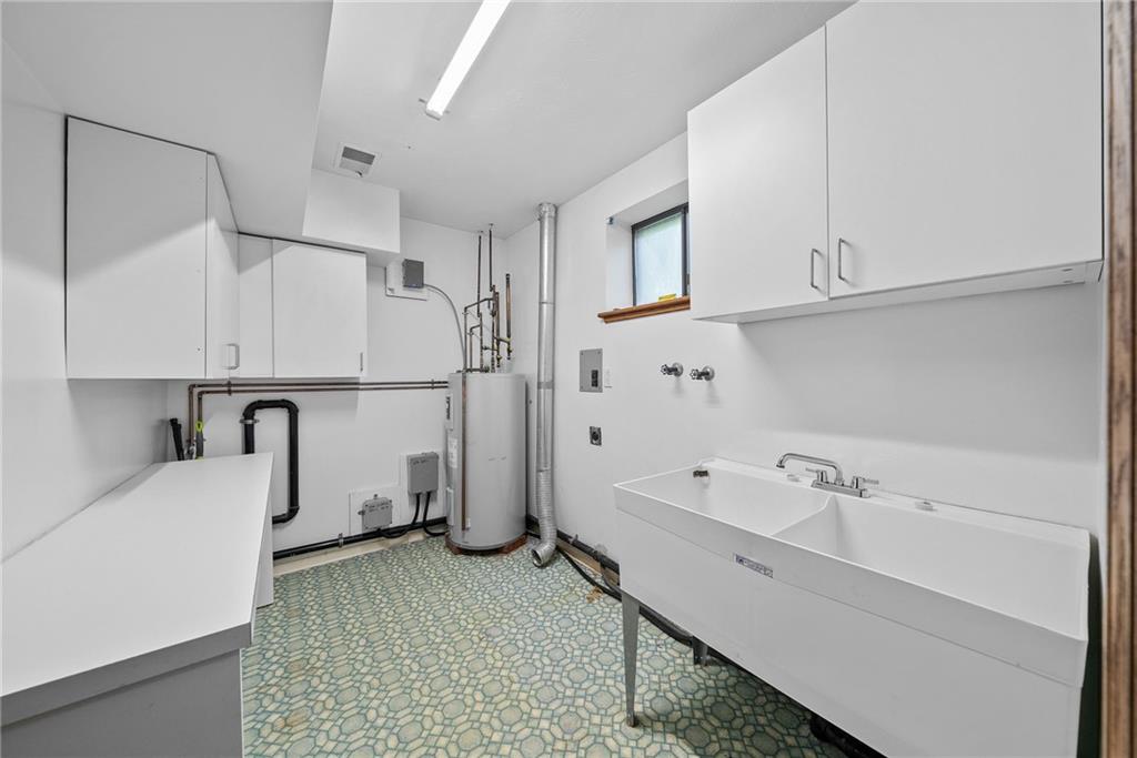 94 Ohare Road Canonsburg, PA 15317 - Photo 40 of 50 Functional laundry area featuring generous cabinet storage, utility sink, and room to keep household essentials organized