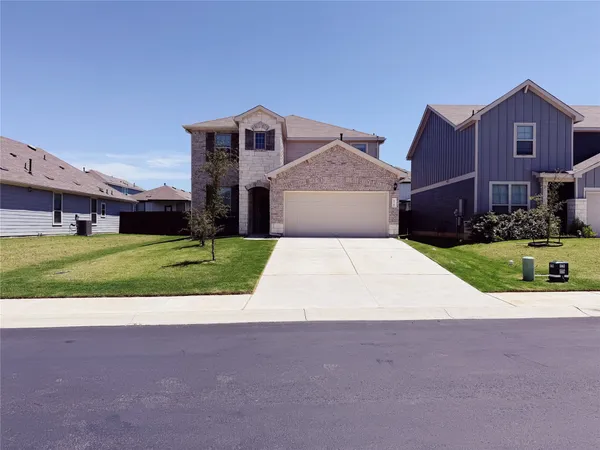 a view of house with yard and garage