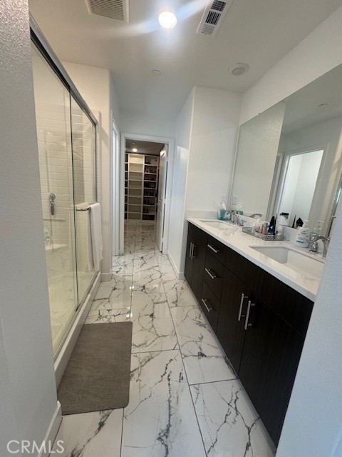 2315 Powell Drive Rialto, CA 92377 - Photo 13 of 27 a spacious bathroom with a double vanity sink a mirror and a shower