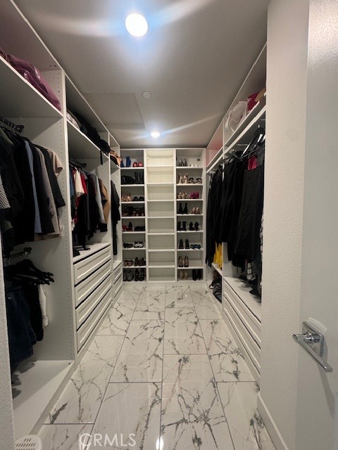 2315 Powell Drive Rialto, CA 92377 - Photo 16 of 27 a view of walk in closet with clothes and shoes