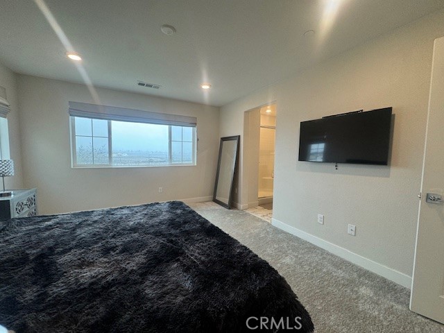 2315 Powell Drive Rialto, CA 92377 - Photo 8 of 27 a bedroom with a bed and a flat screen tv