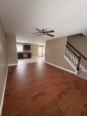 a view of a livingroom with a hardwood floor and a ceiling fan