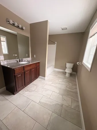 a spacious bathroom with a sink and mirror