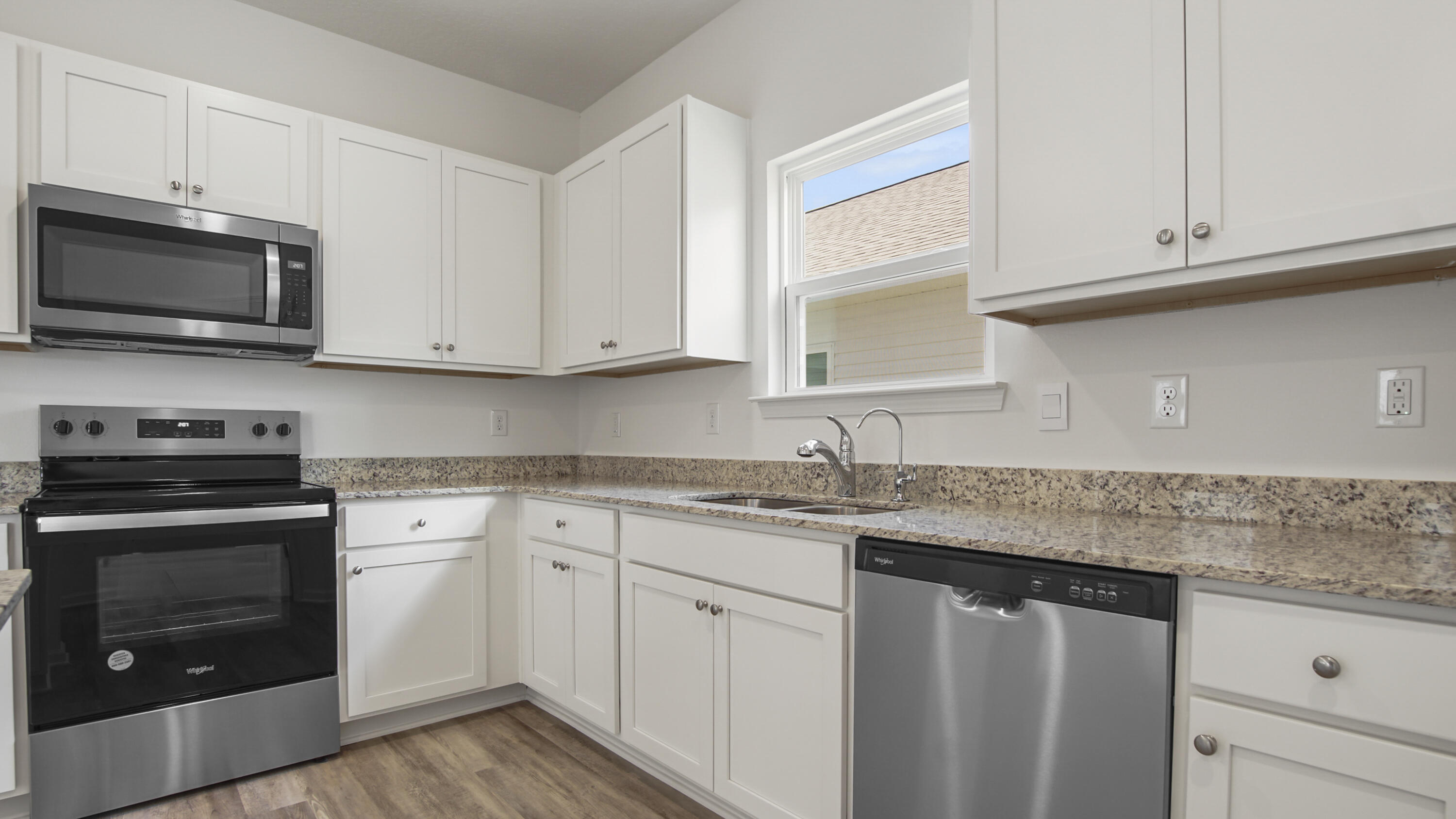 73 Huckleberry Street Freeport, FL 32439 - Photo 12 of 34 a kitchen with appliances cabinets and a sink