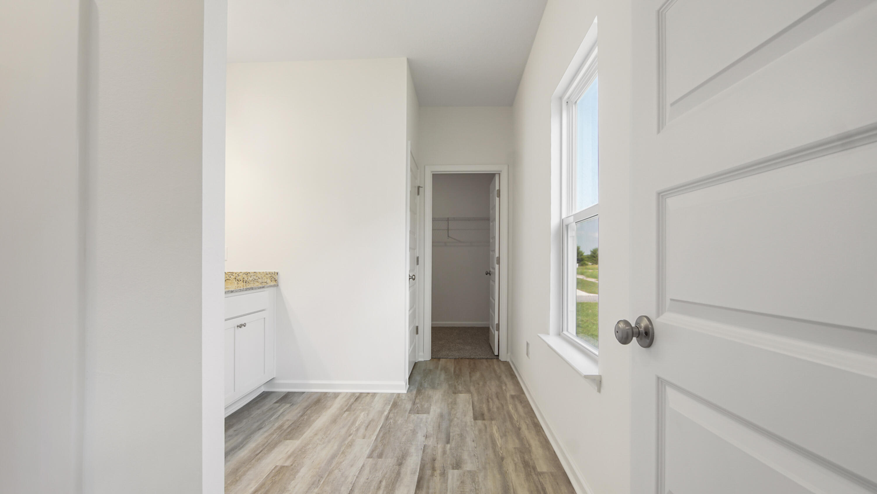 73 Huckleberry Street Freeport, FL 32439 - Photo 18 of 34 a view of a hallway with wooden floor and closet