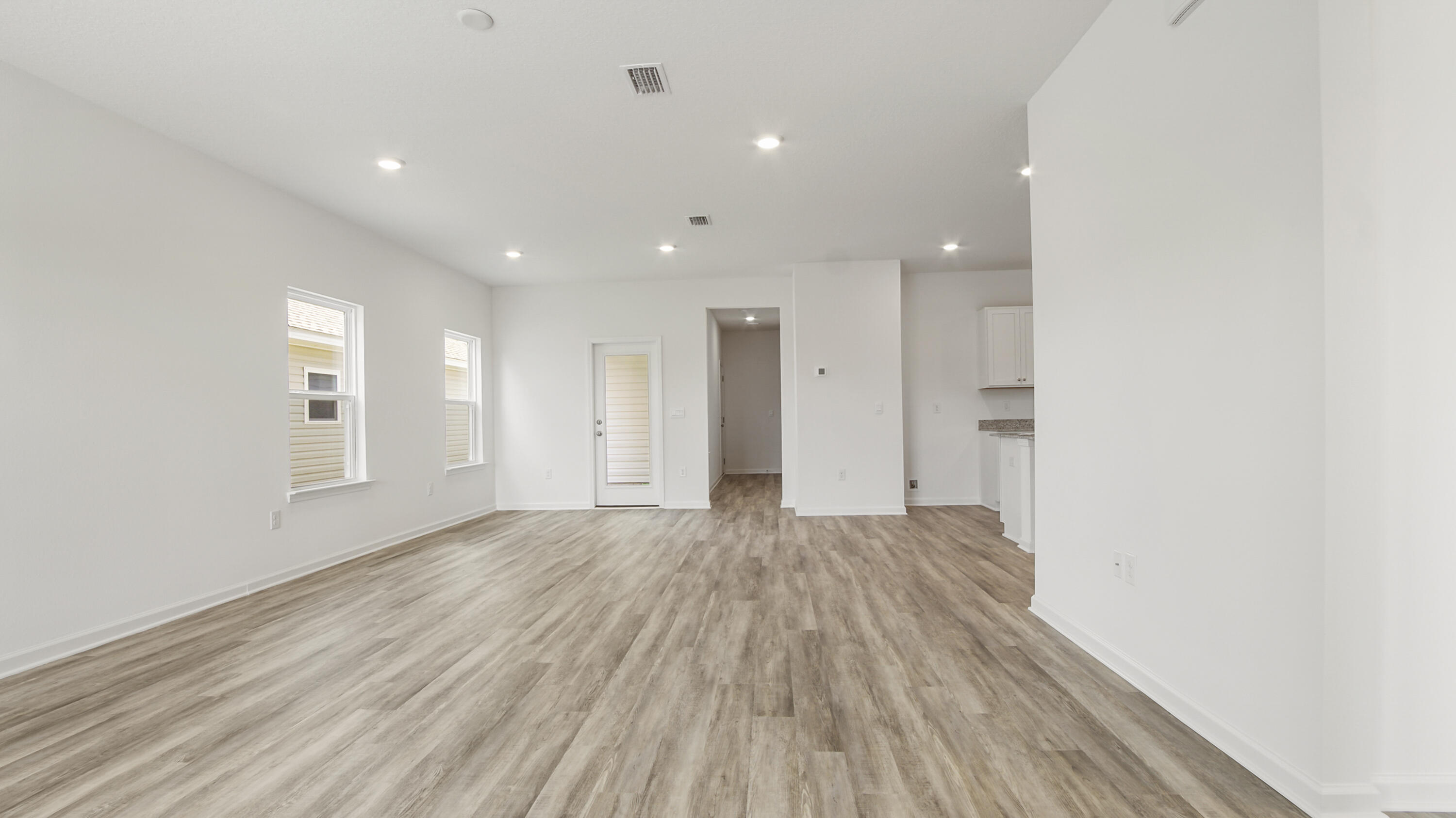 73 Huckleberry Street Freeport, FL 32439 - Photo 4 of 34 a view of an empty room with wooden floor and a window