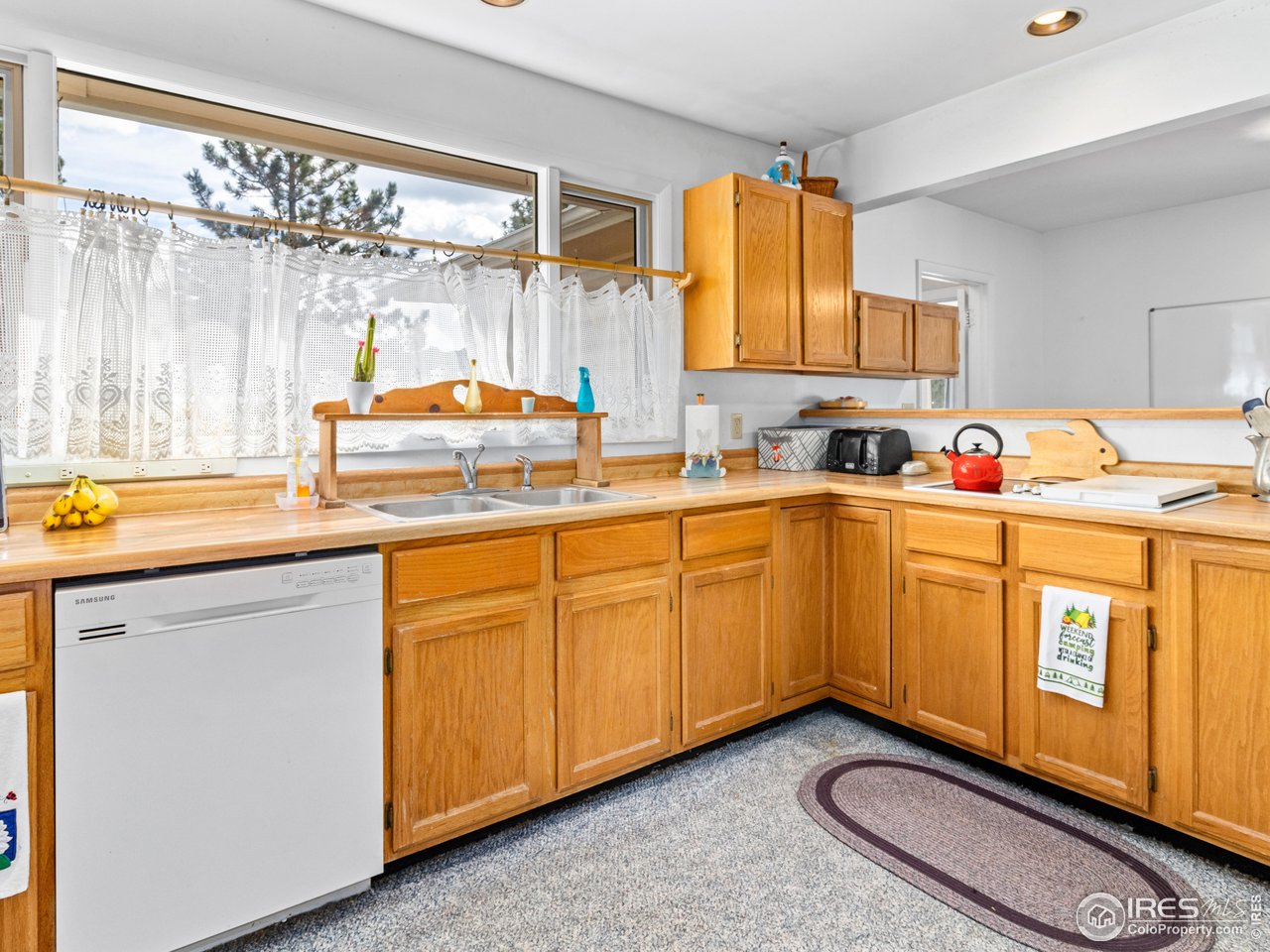 831 Larkspur Road Estes Park, CO 80517 - Photo 14 of 32 The kitchen has ample storage that is well laid out.