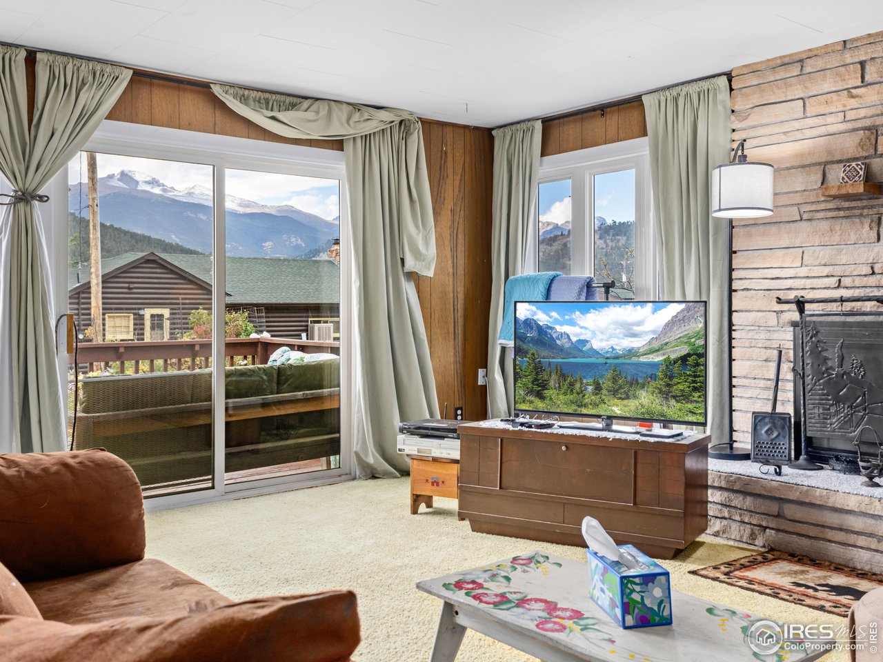831 Larkspur Road Estes Park, CO 80517 - Photo 7 of 32 Sit and take in the stunning views of the Great Divide from the warmth of this living room.