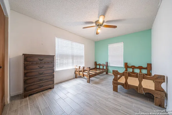 a bedroom with furniture and a large window