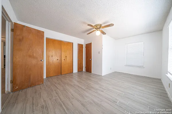 a view of an empty room with wooden floor