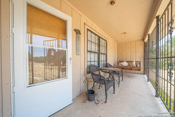 a view of a livingroom with furniture and floor to ceiling window