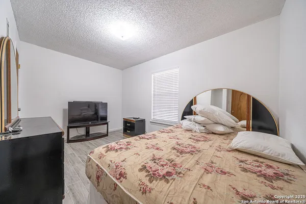 a bedroom with a bed and a dresser