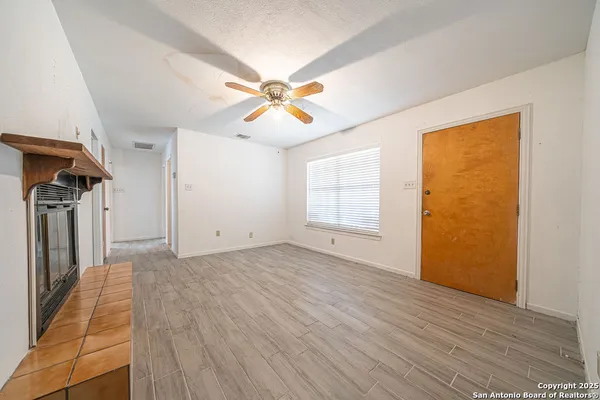 a view of empty room with wooden floor