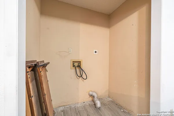 a view of a room with wooden floor and windows