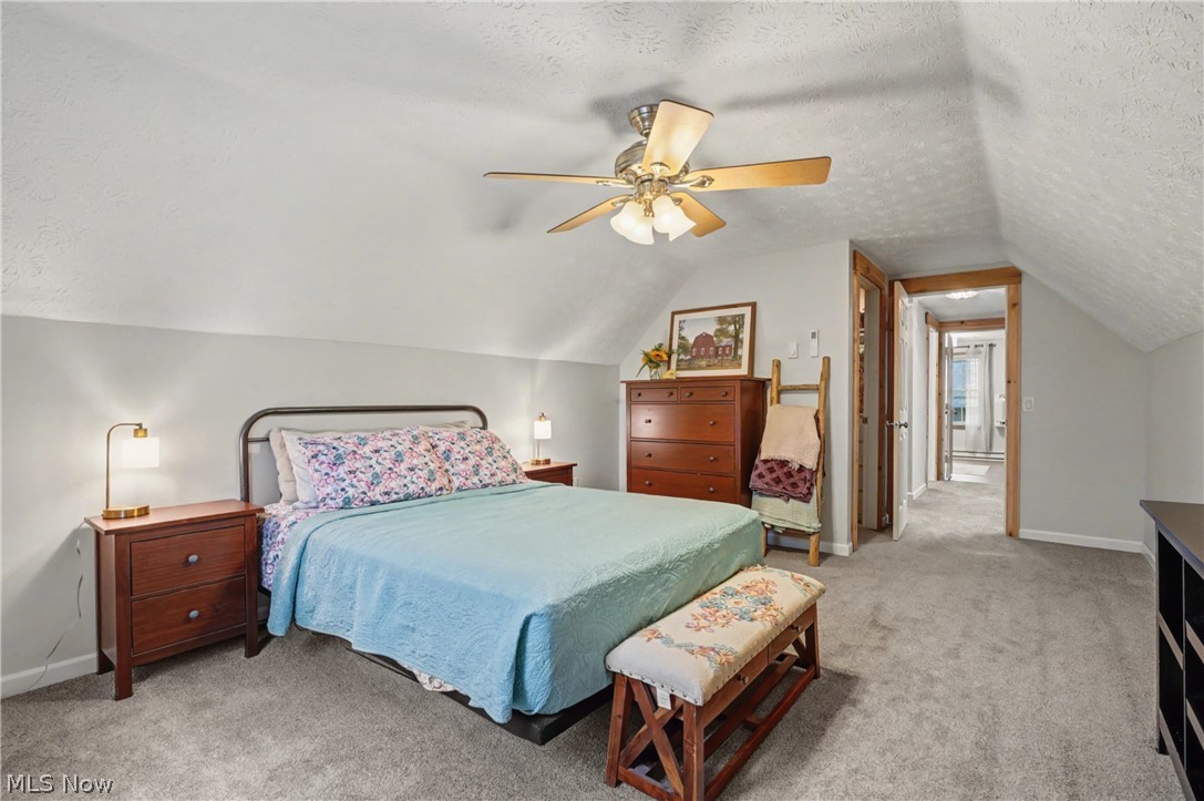 4556 Rootstown Road Ravenna, OH 44266 - Photo 27 of 50 Bedroom featuring a textured ceiling, light carpet, and ceiling fan