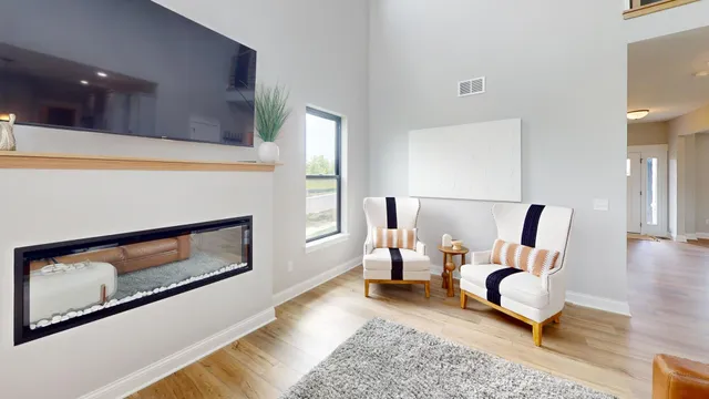 a living room with furniture wooden floor and a fireplace