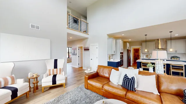 a living room with furniture kitchen and a table