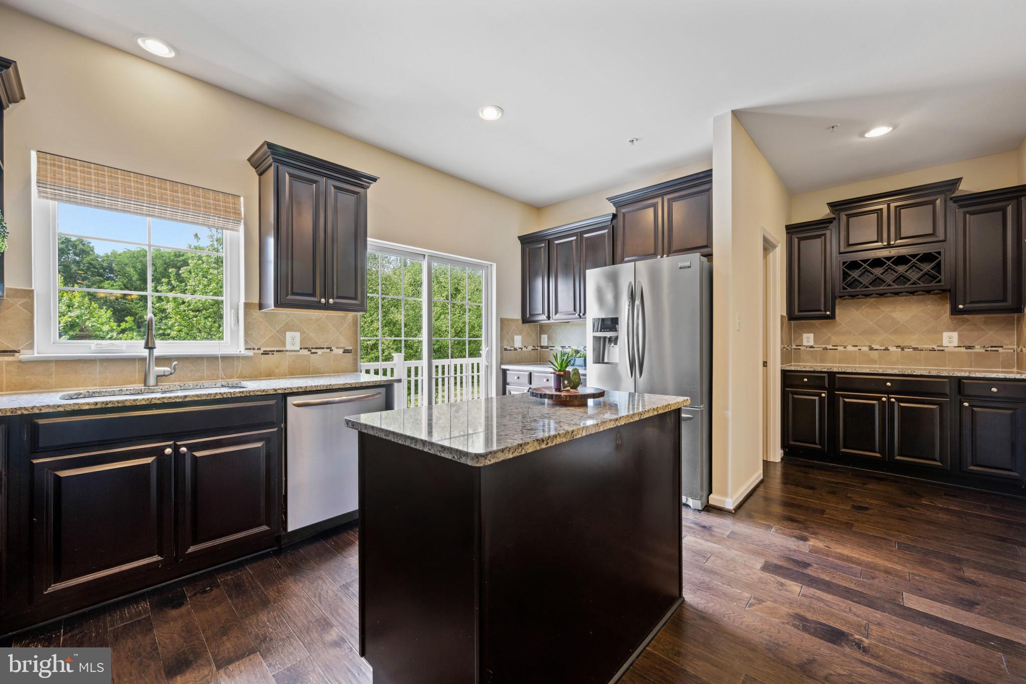 7062 Foxton Way Hanover, MD 21076 - Photo 13 of 41 a kitchen with stainless steel appliances granite countertop a refrigerator a sink a stove a washer dryer and a refrigerator