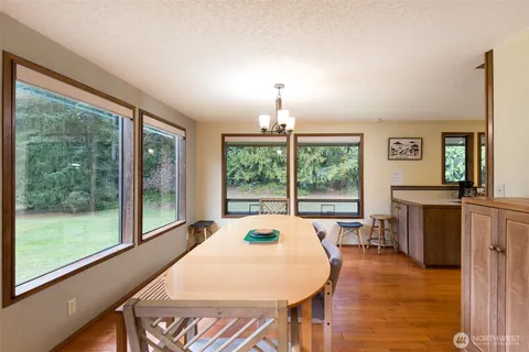 a living room with fireplace furniture and a large window