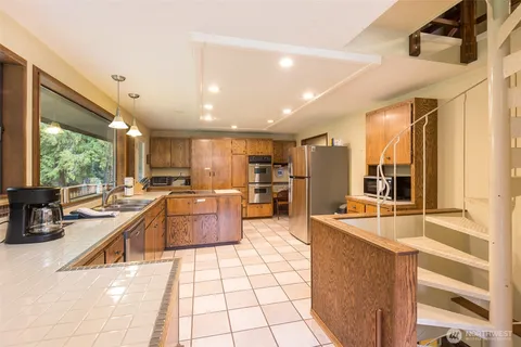 a large kitchen with stainless steel appliances kitchen island granite countertop a large counter top stainless steel appliances and cabinets