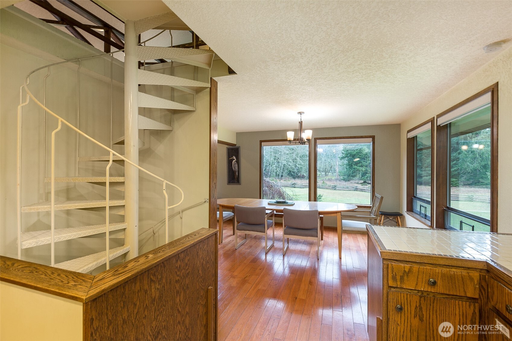 3547 Deer Park Road Port Angeles, WA 98362 - Photo 16 of 37 a living room with furniture large windows and wooden floor
