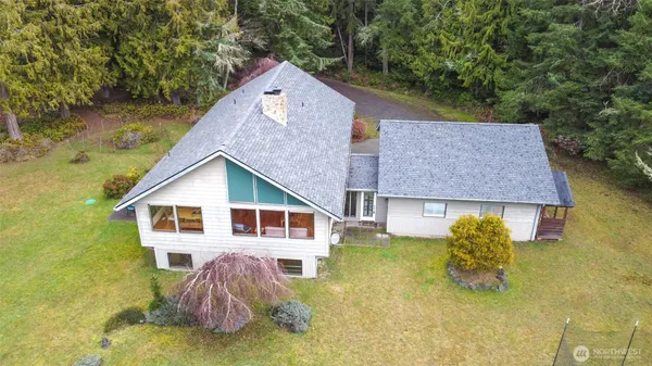 a aerial view of a house with swimming pool next to a yard