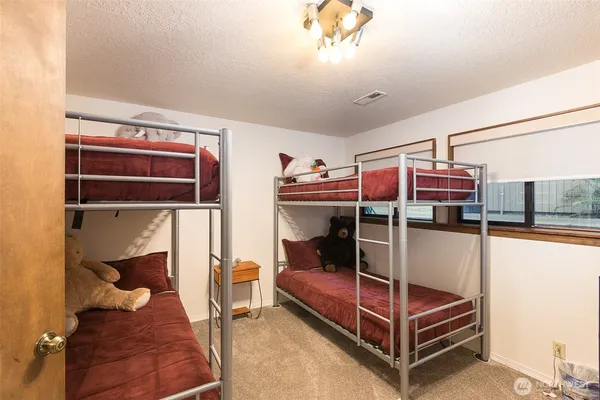 a bedroom with a bunk bed and a window