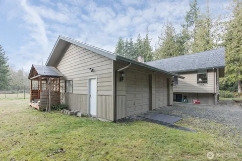 a view of a house with a yard and garage