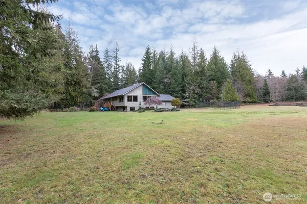 a view of an house with backyard space and garden