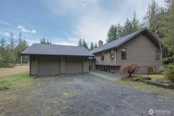 a view of a house with a yard and garage